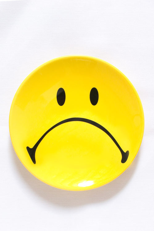 a smiley-face plate whose smile has been turned upside-down