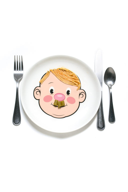 a smiling plate with a face on it; green peas arranged in a hitler mustache