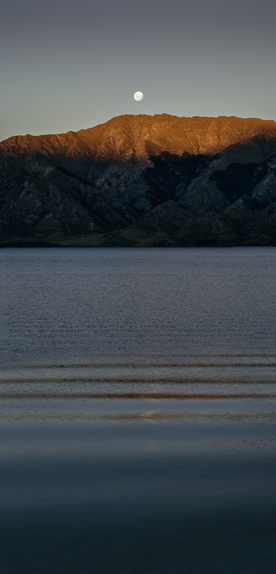 A very tall panorama of the moon over Lake Wanaka.